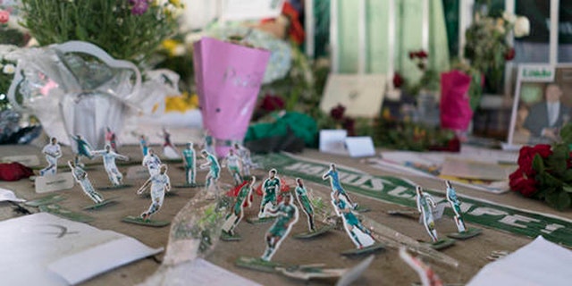 Miniature paper figures of Chapecoense soccer players adorn a makeshift memorial at the clubs stadium Conda Arena in Chapeco, Brazil, Friday, Dec. 2, 2016. The bodies of the Brazilian victims will be repatriated later Friday on three flights to Chapeco, the hometown of the Chapecoense Brazilian soccer team. Members of the team and a group of journalists who perished on the flight were headed to the Copa Sudamericana finals when the plane ran out of fuel, crashing into the Andes outside Medellin.  (AP Photo/Renata Brito)