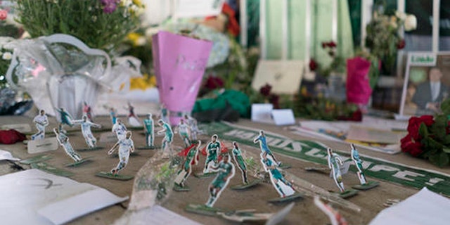 Miniature paper figures of Chapecoense soccer players adorn a makeshift memorial at the clubs stadium Conda Arena in Chapeco, Brazil, Friday, Dec. 2, 2016. The bodies of the Brazilian victims will be repatriated later Friday on three flights to Chapeco, the hometown of the Chapecoense Brazilian soccer team. Members of the team and a group of journalists who perished on the flight were headed to the Copa Sudamericana finals when the plane ran out of fuel, crashing into the Andes outside Medellin. (AP Photo/Renata Brito)