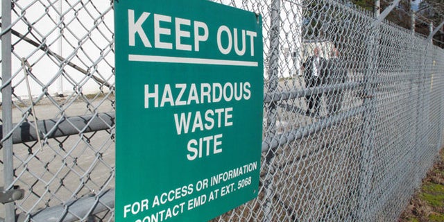 A sign cautions visitors outside a "pump and treat" facility on the Marine base at Camp Lejeune, N.C., on Wednesday, Feb. 27, 2013. The sprawling installation is the site of one of the worst drinking water contaminations in U.S. history.