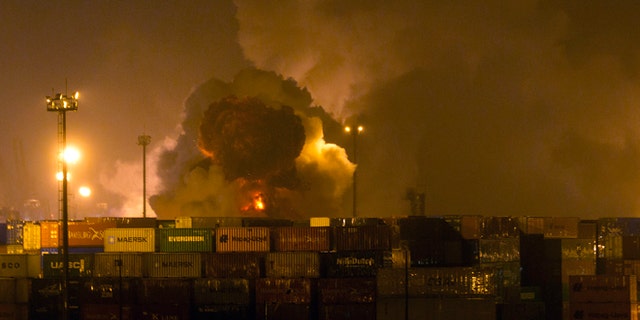 Smoke rises from a tank at a warehouse in the coastal city of Guaruja, Brazil, Thursday, Jan. 14, 2016.