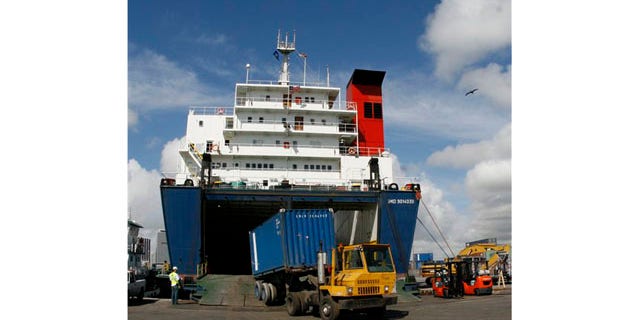 Feb. 4: A container is unloaded from the cargo vessel Seaboard Sun while docked at the Port of Miami in Florida. U.S. companies sold fewer products overseas in February but the trade deficit still narrowed because of a big decline in oil imports.