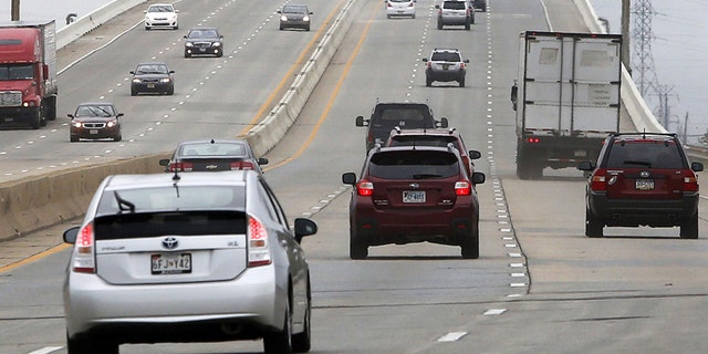Traffic flows along the northbound lanes of Interstate 495 over the Christina River, Saturday afternoon, Aug. 23, 2014, after Delaware transportation officials reopened the highway after completing repairs to the bridge. The bridge was closed in early June because several supporting columns were tilting. (AP Photo/The Wilmington News-Journal, William Bretzger)