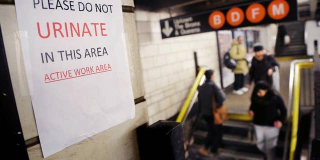 A sign in the West 4th Street subway station reads