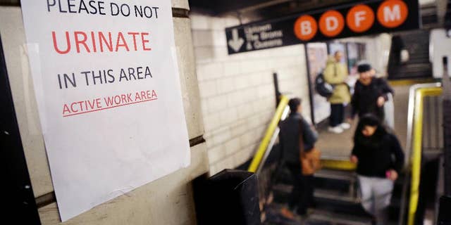 A sign in the West 4th Street subway station reads 