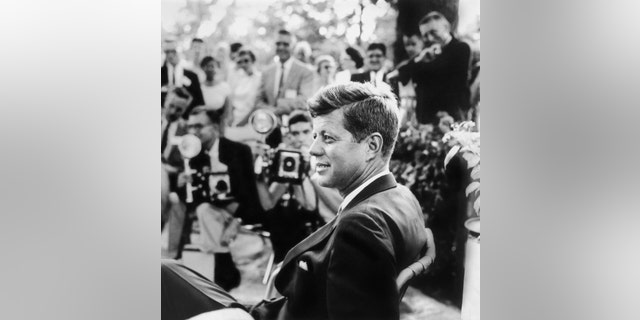 FILE - This handout photo provided by the Newseum, and the estate of Jacques Lowe, shows John F. Kennedy at a news conference in Omaha, Neb. in 1959.  Three cities loom large in the life and death of John F. Kennedy: Washington, D.C., where he served as U.S. president and as a senator; Dallas, where he died, and Boston, where he was born. With the 50th anniversary of his Nov. 22, 1963 assassination at hand, all three places are worth visiting to learn more about him or to honor his legacy.(AP Photo/Newseum, estate of Jacques Lowe)