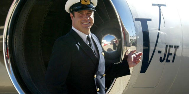 FILE: John Travolta, shown in front of his jet in 2002.