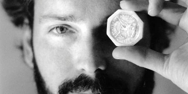 FILE -In this November 1989 file photo, Tommy Thompson holds a $50 pioneer gold piece retrieved earlier in 1989 from the wreck of the gold ship Central America. According to the US Marshals Service, Thompson, a fugitive treasure hunter wanted for more than 2 years was arrested in Florida. (AP Photo/The Columbus Dispatch, Lon Horwedel)