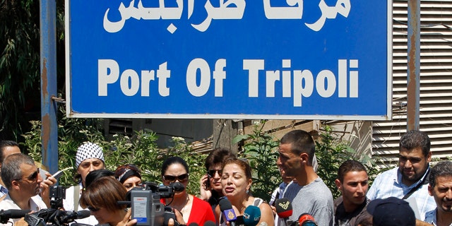 Aug. 19: Lebanese Samar al-Hajj, center, one of the organizers of Mariam ship that plans to sail to Gaza Strip, speaks during a press conference outside the seaport of Tripoli in Lebanon. (AP photo)