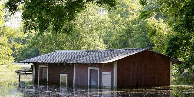 May 18, 2011: A partially-flooded building on the banks of the Atchafalaya River outside of the levee protection area in Simmesport, La.