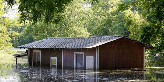 May 18, 2011: A partially-flooded building on the banks of the Atchafalaya River outside of the levee protection area in Simmesport, La.