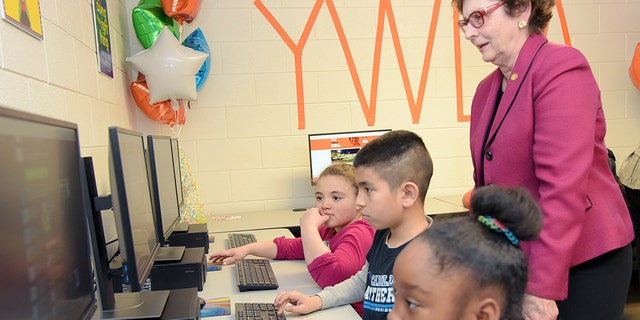 North Carolina State Sen. Trudy Wade, seen in January 2018, watches as students log on to computers in a new technology lab.