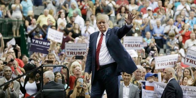 Republican presidential candidate Donald Trump waved to his supporters after a campaign speech in Dallas on September 1. 14, 2015. (AP Photo/LM Otero)