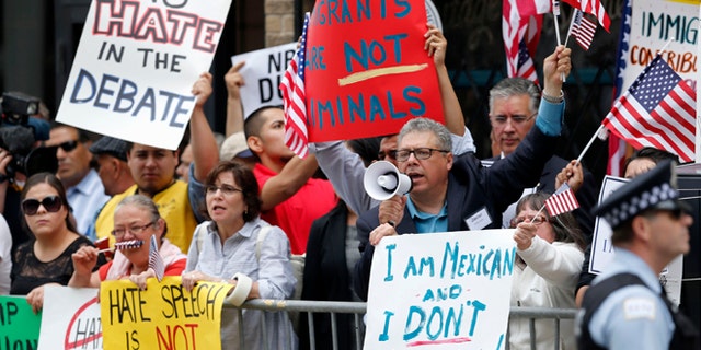 Protesters gather across the street from a restaurant in Chicago.