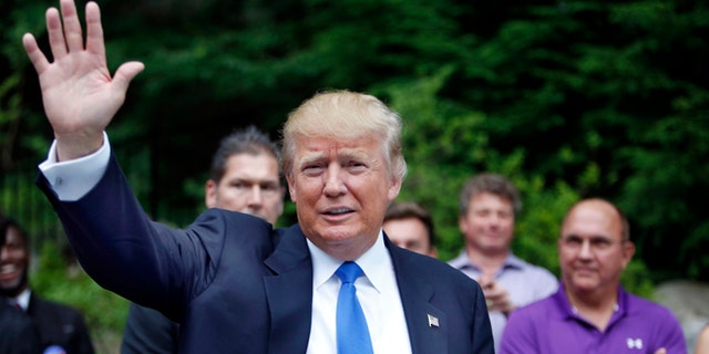 FILE - In this Tuesday, June 30, 2015 file photo, Republican presidential candidate Donald Trump waves as he arrives at a house party in Bedford, N.H. Alex Nogales, president of the National Hispanic Media Coalition, said Thursday, July 9, 2015, that more organizations need to follow the example of NBC and cut business ties with Trump.  (AP Photo/Jim Cole, File)