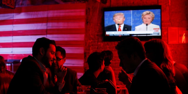 Customers watch the presidential debate at the Pinche Gringo BBQ restaurant in Mexico City, on Oct. 19, 2016.