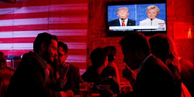 Customers watch the presidential debate at the Pinche Gringo BBQ restaurant in Mexico City, on Oct. 19, 2016.