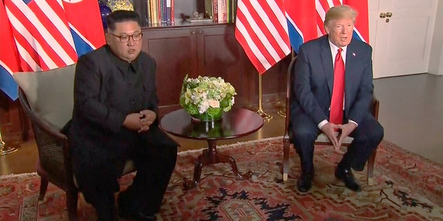 In this image made from video provided by Host Broadcaster Mediacorp Pte Ltd,, U.S. President Donald Trump and North Korean leader Kim Jong Un sit together for their meeting at Capella Hotel in Singapore, Tuesday, June 12, 2018. (Host Broadcaster Mediacorp Pte Ltd via AP)