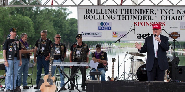 Republican presidential candidate Donald Trump, right, speaks to supporters and bikers at a Rolling Thunder rally at the National Mall in Washington, Sunday, May 29, 2016. (AP Photo/Manuel Balce Ceneta)