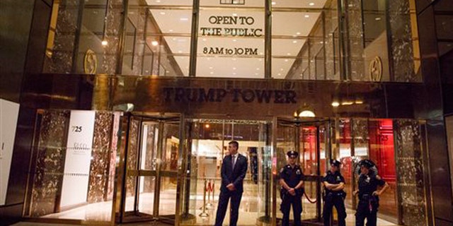 New York police and security stand outside Trump Tower on, Saturday, Oct. 8, 2016, in New York. Republican presidential candidate Donald Trump blurted out lewd and sexually charged comments about women as he waited to make a cameo appearance on a soap opera in 2005, a revelation that led him to issue a rare apology. (AP Photo/ Evan Vucci)