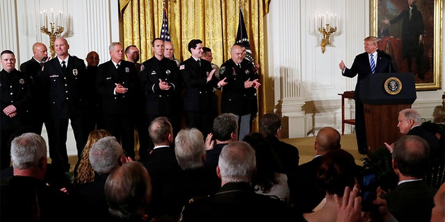 President Donald Trump applauds for Medal of Valor recipients during a Public Safety Medal of Valor Awards Ceremony at the White House in Washington, U.S., February 20, 2018.