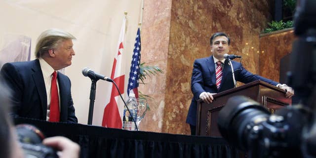 Real estate developer Donald Trump, left, listens to Mikhail Saakashvili, President of Georgia, at a news conference in New York, Thursday, March 10, 2011. Trump and a Georgian development group have agreed to build a Trump Tower in Georgia. Trump indicated he is seriously considering a run for the U.S. presidency. (AP Photo/Mark Lennihan)
