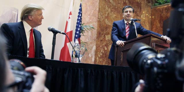 Real estate developer Donald Trump, left, listens to Mikhail Saakashvili, President of Georgia, at a news conference in New York, Thursday, March 10, 2011. Trump and a Georgian development group have agreed to build a Trump Tower in Georgia. Trump indicated he is seriously considering a run for the U.S. presidency. (AP Photo/Mark Lennihan)