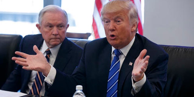 FILE - In this Oct. 7, 2016 file photo, then Sen. Jeff Sessions, R-Ala. listens at left as then-Republican presidential candidate Donald Trump speaks during a national security meeting with advisers at Trump Tower in New York.