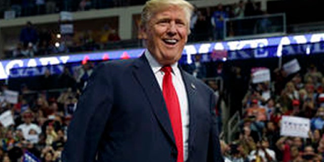 Republican presidential candidate Donald Trump smiles as he arrives to speak to a campaign rally, Friday, Nov. 4, 2016, in Hershey, Pa. (AP Photo/ Evan Vucci)