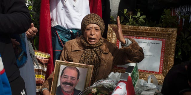 A protestor holds a portrait of slain Tunisian opposition leader Chokri Belaid, during a demonstration to mark 40 days since his death, in Tunis, Saturday, March 16, 2013. (AP Photo/Amine Landoulsi)