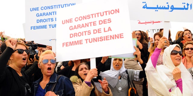 November 2: Tunisian women demonstrate for their rights during a protest in Tunis. Placards read in French: A constitution guaranteeing the rights of the Tunisian women.