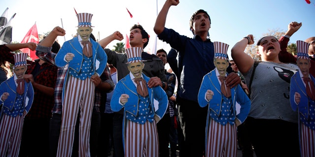 Nov. 15, 2015: Members of Turkey Youth Union hold effigies of U.S. President Barack Obama during a protest in Antalya, Turkey.