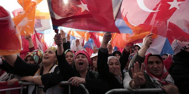 The supporters listen to Turkish Prime Minister Recep Tayyip Erdogan who addressed a rally of his Justice and Development Party in Istanbul, Turkey, Sunday, March 23, 2014. Turkish fighter jets shot down a Syrian warplane after it violated Turkey's airspace Sunday, Erdogan said, in a move likely to ramp up tensions between the two countries already deeply at odds over Syria's civil war. Erdogan is fighting corruption allegations against his government a week before local elections that are seen as a referendum over his rule. (AP Photo/Emrah Gurel)