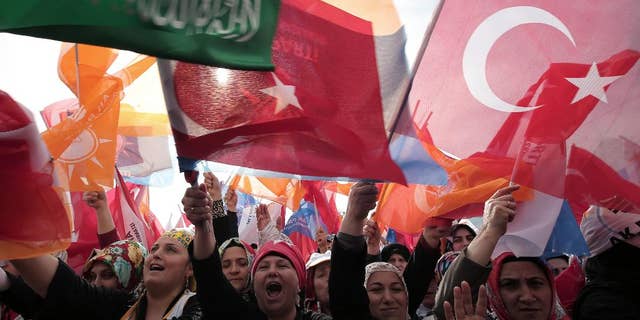 The supporters listen to Turkish Prime Minister Recep Tayyip Erdogan who addressed a rally of his Justice and Development Party in Istanbul, Turkey, Sunday, March 23, 2014. Turkish fighter jets shot down a Syrian warplane after it violated Turkey's airspace Sunday, Erdogan said, in a move likely to ramp up tensions between the two countries already deeply at odds over Syria's civil war. Erdogan is fighting corruption allegations against his government a week before local elections that are seen as a referendum over his rule. (AP Photo/Emrah Gurel)
