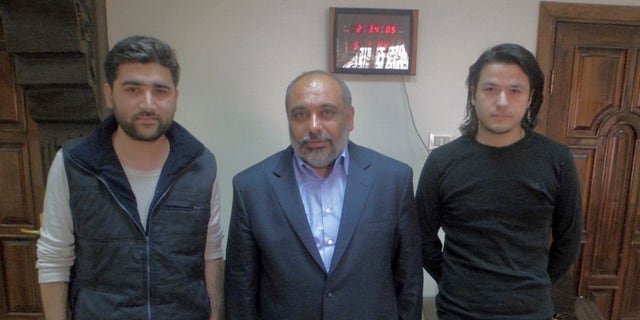 May 5, 2012: - In this file photo provided by pro-Islamic aid group known by its Turkish acronym IHH, showing Turkish journalists Adem Ozkose, left, and Hamit Coskun, right, with the IHH Chairman Bulent Yildirim, centre, in Damascus, Syria.