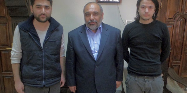 May 5, 2012: - In this file photo provided by pro-Islamic aid group known by its Turkish acronym IHH, showing Turkish journalists Adem Ozkose, left, and Hamit Coskun, right, with the IHH Chairman Bulent Yildirim, centre, in Damascus, Syria.