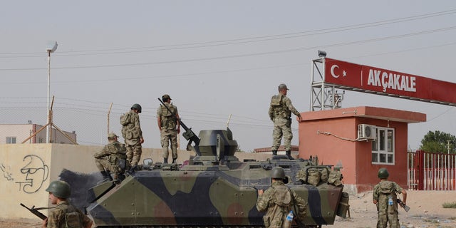 Turkish military station at the border gate with Syria, across from Syrian rebel-controlled Tel Abyad town, in Akcakale, Turkey, Sunday, Oct. 7, 2012. (AP Photo)