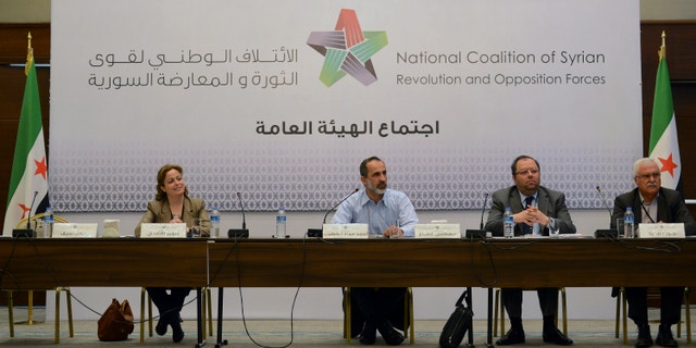 March 18, 2013 - Head of the new Syrian National Coalition for Opposition and Revolutionary Forces Mouaz al-Khatib, second left, speaks with other unidentified members, during a meeting in Istanbul, Turkey.