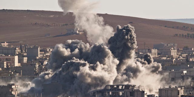 Nov. 9, 2014: Smoke rises in the Syrian town of Kobani, after an airstrike by the US led coalition, seen from a hilltop outside Suruc, on the Turkey-Syria border. (AP)
