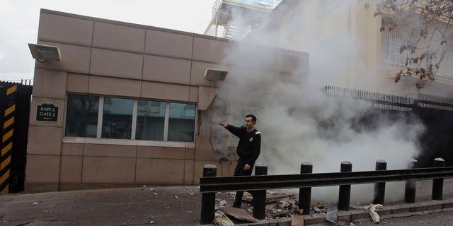 Feb. 1, 2013: An embassy security guard asks for help at the US embassy just minutes after a suicide bomber has detonated an explosive device at the entrance of the U.S. Embassy in the Turkish capital, Ankara, Turkey.