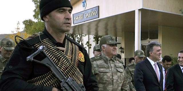 Oct. 14, 2011: Turkish President Abdullah Gul, right, and Chief of Staff Gen. Necdet Ozel, center, walk in Hakkari, Turkey as they visit Turkish troops at the border with Iraq.
