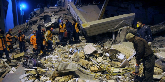 Nov. 9: Rescuers search for survivors in the rubble of a collapsed hotel in Van, eastern Turkey.