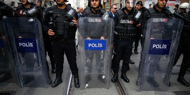 Turkey's police officers looking on as supporters of Turkey's main opposition Republican People's Party, CHP, gather to protest near central Istanbul's Taksim Square.