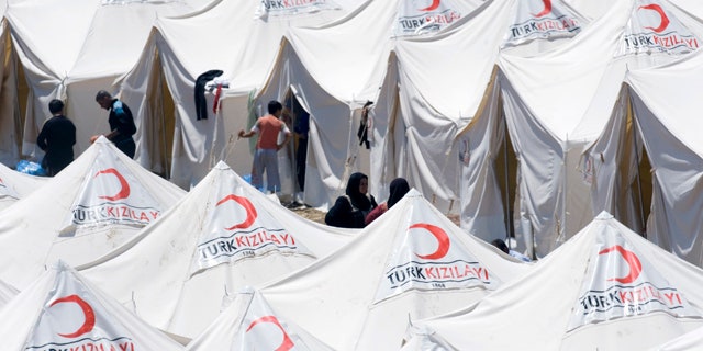 June 19: Syrian refugees are seen in a newly opened refugee camp in Yayladagi, Turkey.
