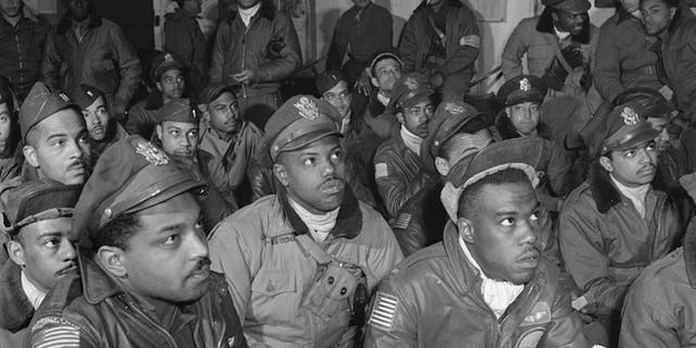 Several Tuskegee airmen attending a briefing in Ramitelli, Italy in March 1945.