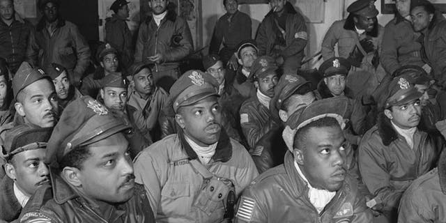 Several Tuskegee airmen attending a briefing in Ramitelli, Italy in March 1945.