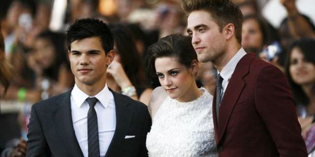 FILE: 'Twilight' stars Taylor Lautner, Kristen Stewart and Robert Pattinson pose for cameras at the premiere of the film.
