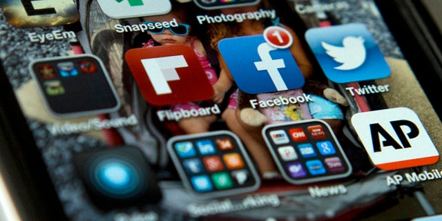 A view of an iPhone in Washington Tuesday, May 21, 2013, showing the Twitter and Facebook apps among others. A new poll finds that teens are sharing more about themselves on social media. Theyâre also moving increasingly to Twitter to avoid their parents and the "oversharing" that they see on Facebook. (AP Photo/Evan Vucci)