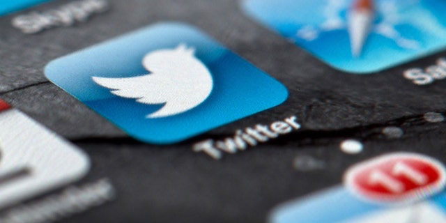 FILE - In this Feb. 2, 2013, file photo, a smartphone display shows the Twitter logo in Berlin, Germany, Twitter unsealed the documents Thursday, Oct. 3, 2013, for its planned initial public offering of stock and says it hopes to raise up to $1 billion. (AP Photo/dpa, Soeren Stache, File)