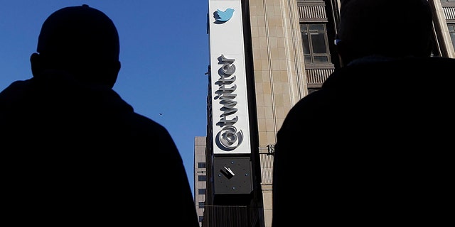 FILE - In this Monday, Nov. 4, 2013, file photo, pedestrians cross the street in front of Twitter headquarters in San Francisco. (AP Photo/Jeff Chiu, File)