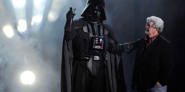 Oct. 15, 2011: In this file photo, "Darth Vader" accepts the Ultimate Villain award from "Star Wars" creator George Lucas during the 2011 Scream Awards, in Los Angeles.